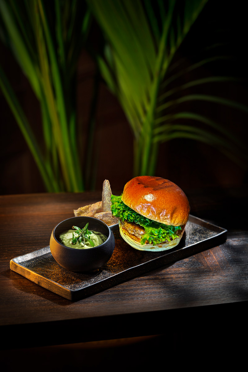 Butterfish burger with guasacaca and fried plantain